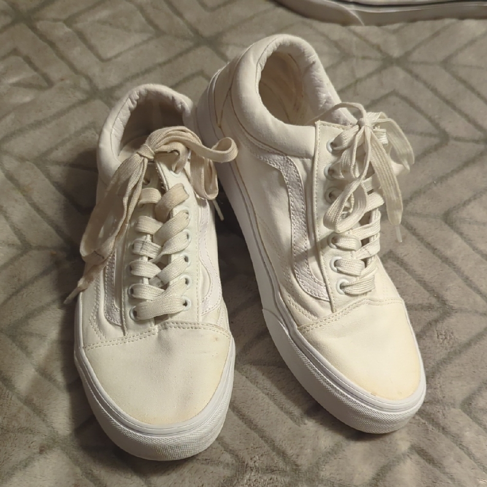 Vans Old Skool shoes in the True White or Monochrome‎ White colorway.
